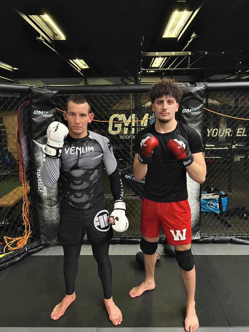Two fighters in the gym, one in the White Edition and one in the Red/Black Edition